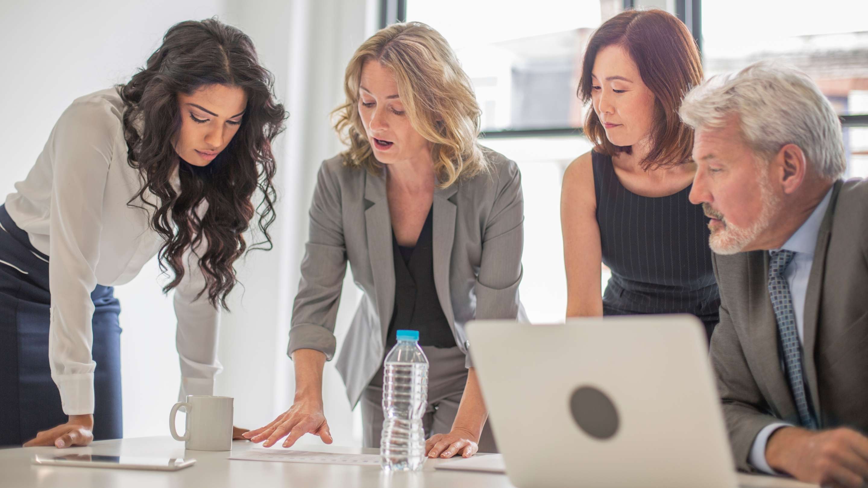Nonprofit board members discussing executive hiring strategy and leadership decisions during a high-stakes meeting in 2026